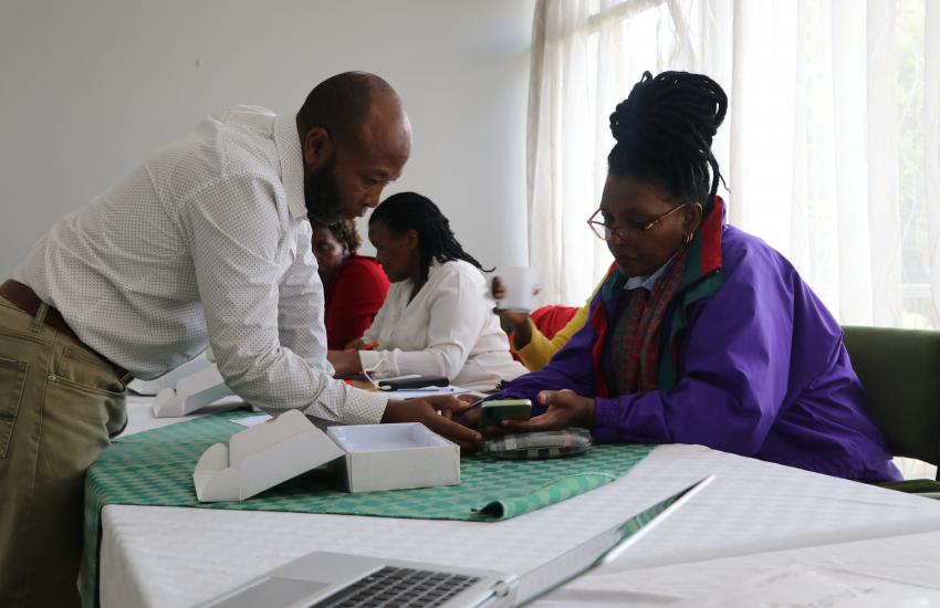 Trainer guides Reseach Assistant during training session