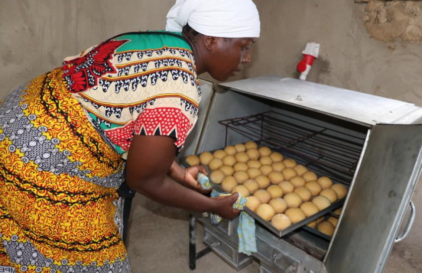 Group member removing scones from oven 