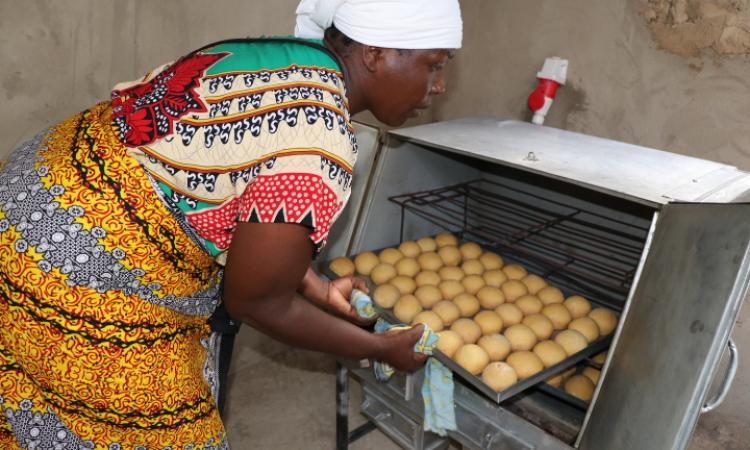 Group member removing scones from oven 