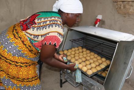 Group member removing scones from oven 
